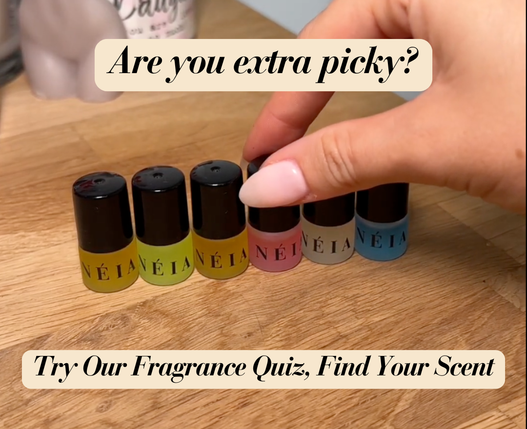 Set of NÉIA fragrance bottles on a wooden surface with text overlay.