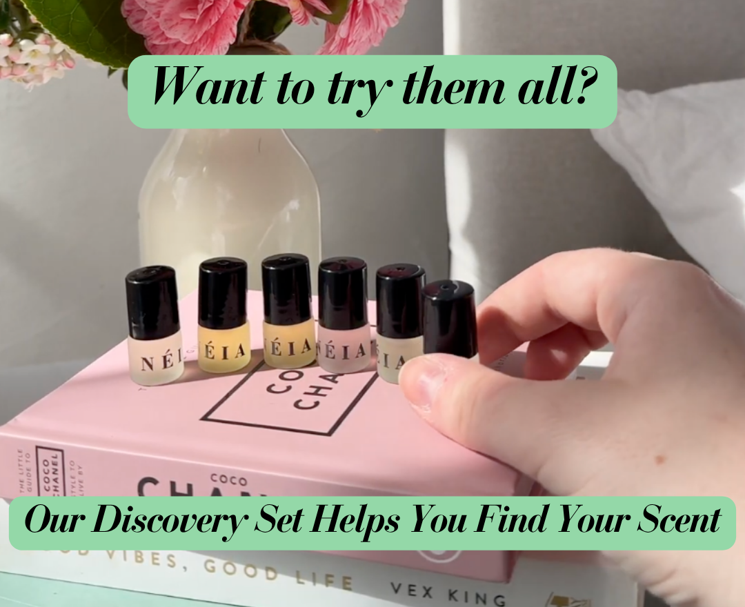 Set of small perfume bottles on a book with text promoting a discovery set.