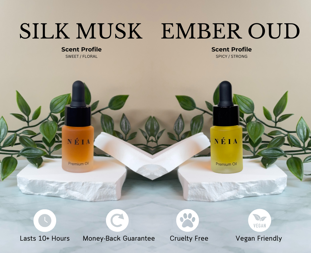 Two bottles of NÉIA premium oils with scent profiles 'Silk Musk' and 'Ember Oud' on a neutral background.