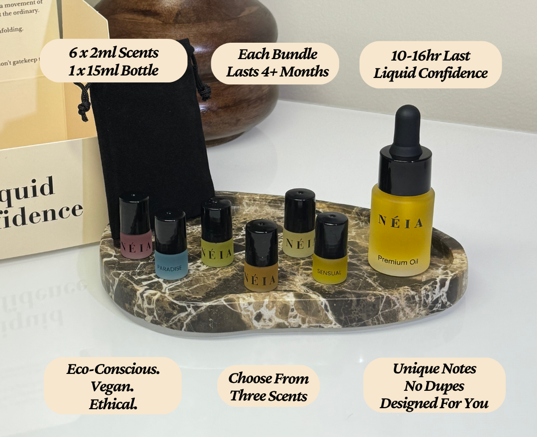 Set of NÉIA perfume oils on a marble stand with product details.