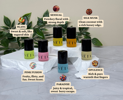 NÉIA perfume oil bottles with descriptive labels on a neutral background