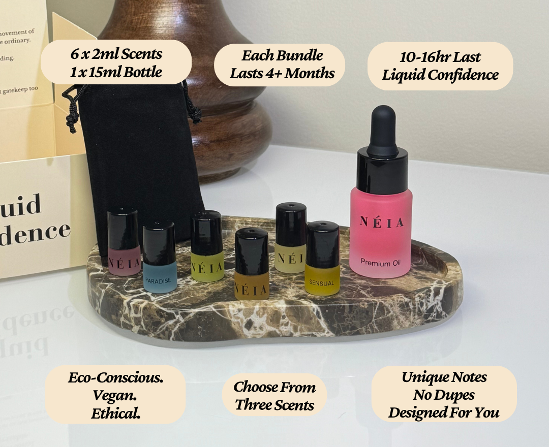 Set of NÉIA premium oils on a marble stand with product details displayed.