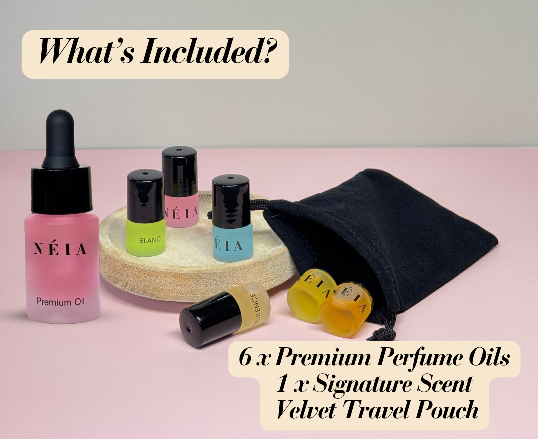 NÉIA premium perfume oils with a velvet travel pouch on a pink background