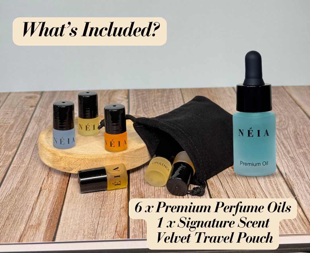 Collection of NÉIA perfume oils and a travel pouch on a wooden surface.