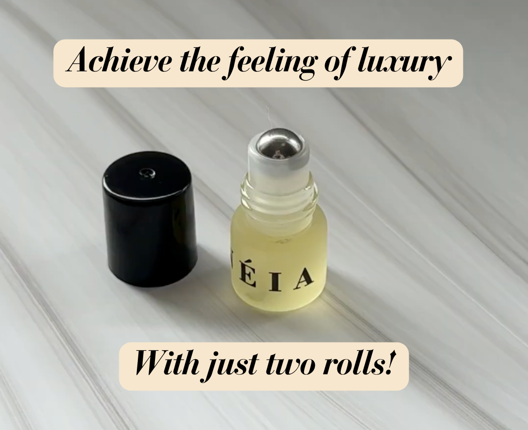 Small bottle and black cap on a light wooden surface with text about achieving luxury with two rolls.