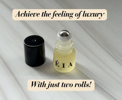 Small bottle and black cap on a light wooden surface with text about achieving luxury with two rolls.