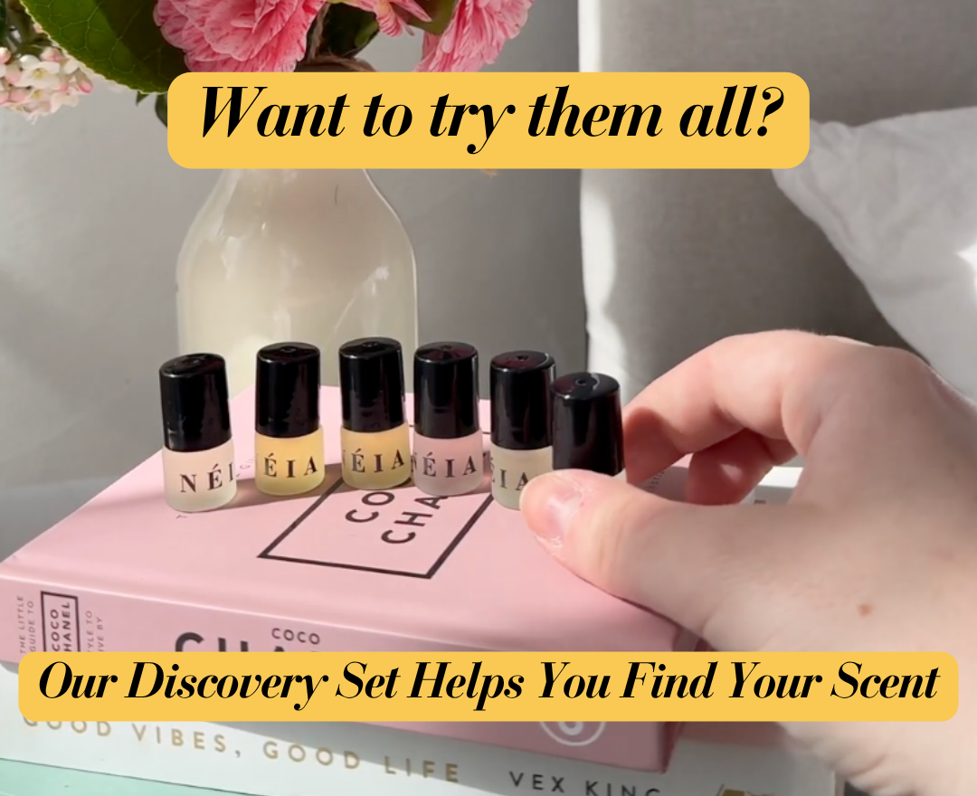 Set of small perfume bottles on a book with text promoting a discovery set.