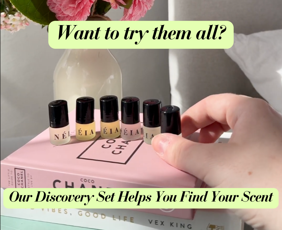 Set of small perfume bottles with black caps on a pink book titled 'Coco Chanel', with text promoting a discovery set.